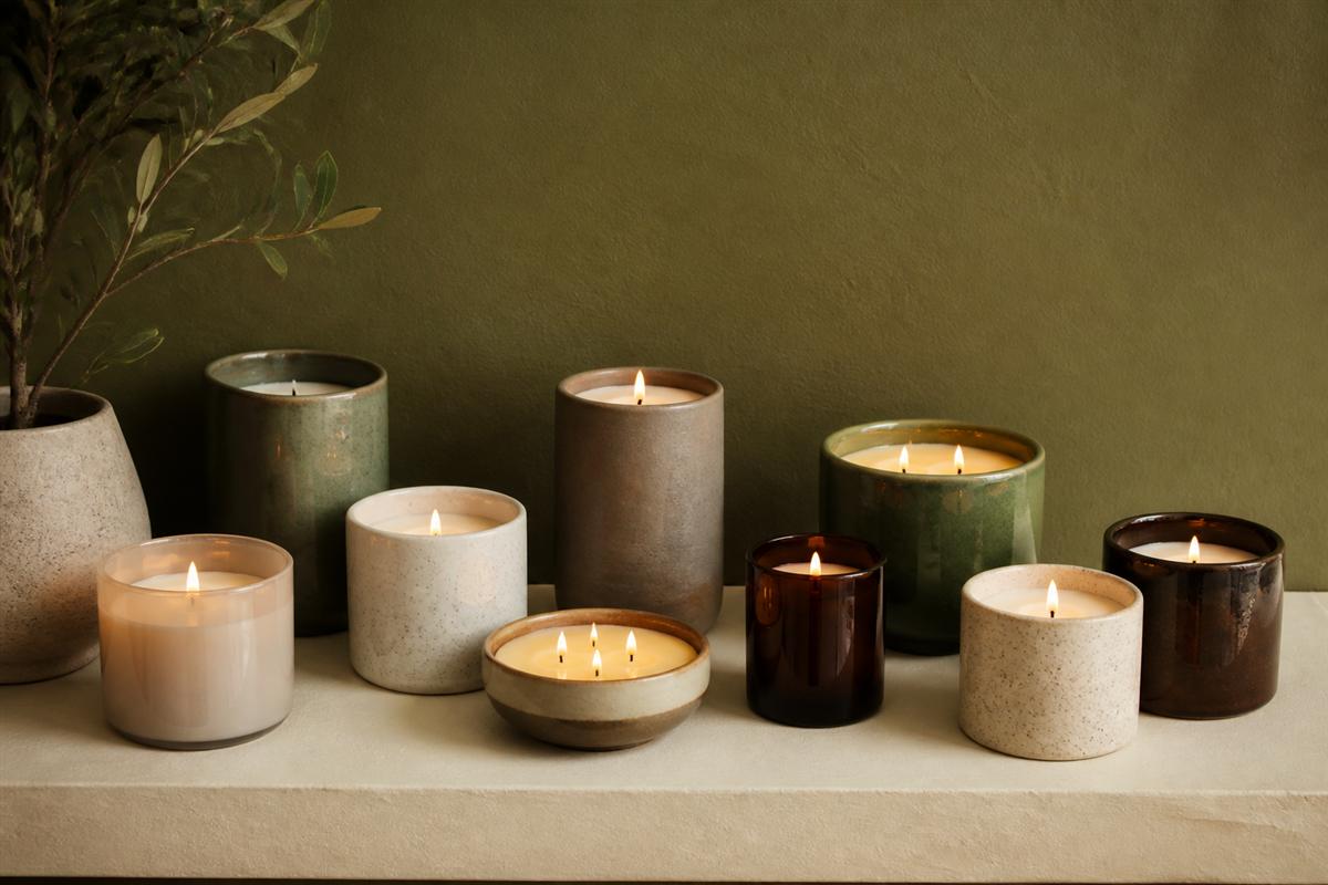 Finished artisan candles on a studio shelf